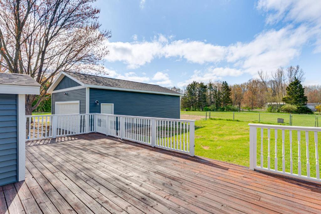 a large deck with a house and a building at Less Than 3 Mi to Double JJ Resort Home with Large Yard! in Rothbury