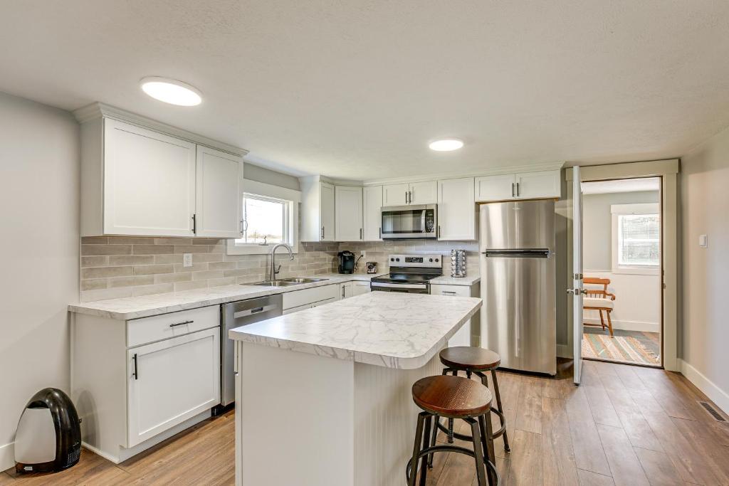 a kitchen with white cabinets and a counter top at Less Than 3 Mi to Double JJ Resort Home with Large Yard! in Rothbury