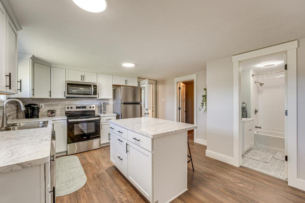 a kitchen with white cabinets and a counter top at Less Than 3 Mi to Double JJ Resort Home with Large Yard! in Rothbury