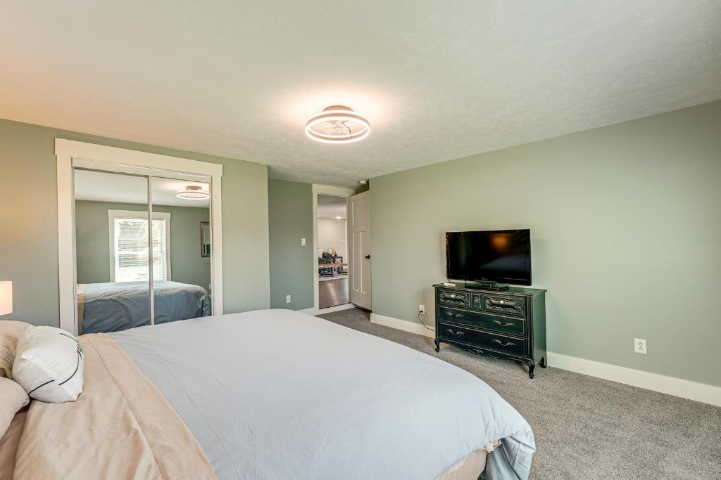 a bedroom with a bed and a flat screen tv at Less Than 3 Mi to Double JJ Resort Home with Large Yard! in Rothbury