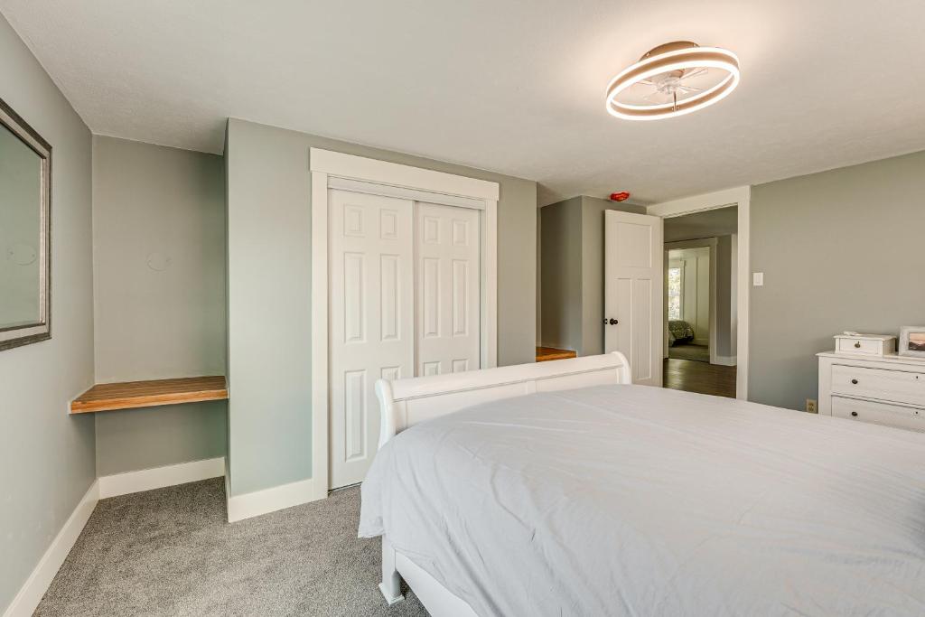 a bedroom with a white bed and a white door at Less Than 3 Mi to Double JJ Resort Home with Large Yard! in Rothbury