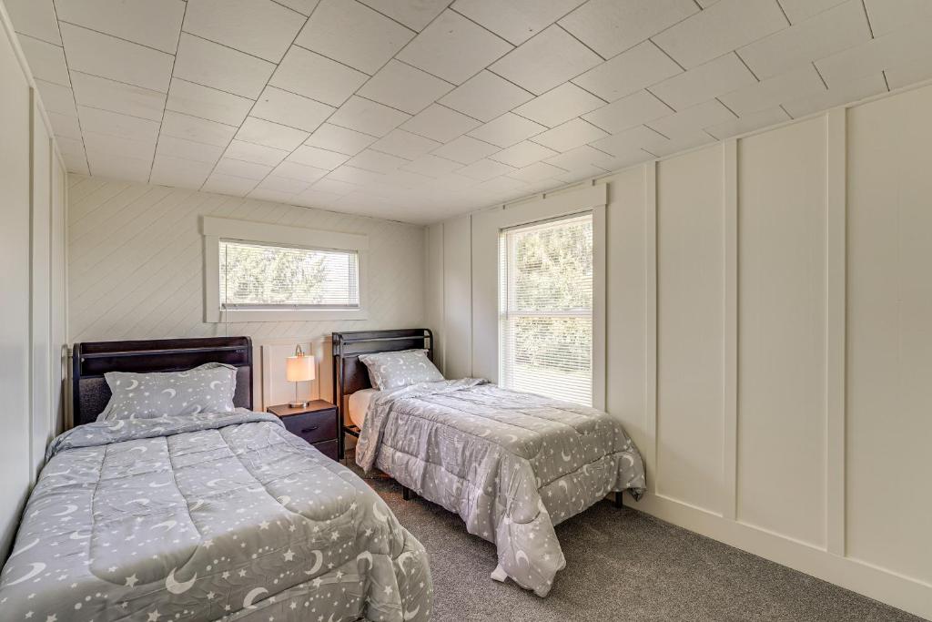 a bedroom with two beds and a window at Less Than 3 Mi to Double JJ Resort Home with Large Yard! in Rothbury