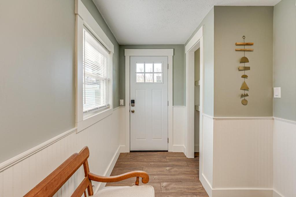 a hallway with a white door and a wooden floor at Less Than 3 Mi to Double JJ Resort Home with Large Yard! in Rothbury