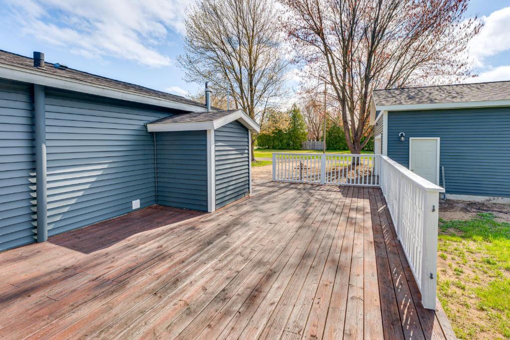 a house with a deck next to a garage at Less Than 3 Mi to Double JJ Resort Home with Large Yard! in Rothbury