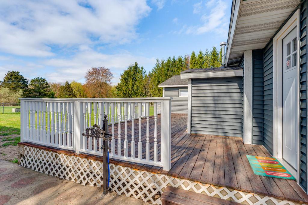 a wooden deck with a white fence on a house at Less Than 3 Mi to Double JJ Resort Home with Large Yard! in Rothbury