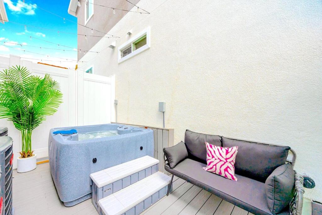 a hot tub sitting on a patio with a couch at D- Hip NoHo Haven Hot Tub - Family - Parking in North Hollywood