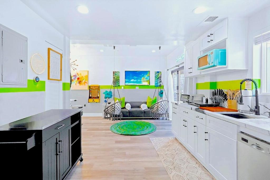 a kitchen with white cabinets and green and white walls at D- Hip NoHo Haven Hot Tub - Family - Parking in North Hollywood