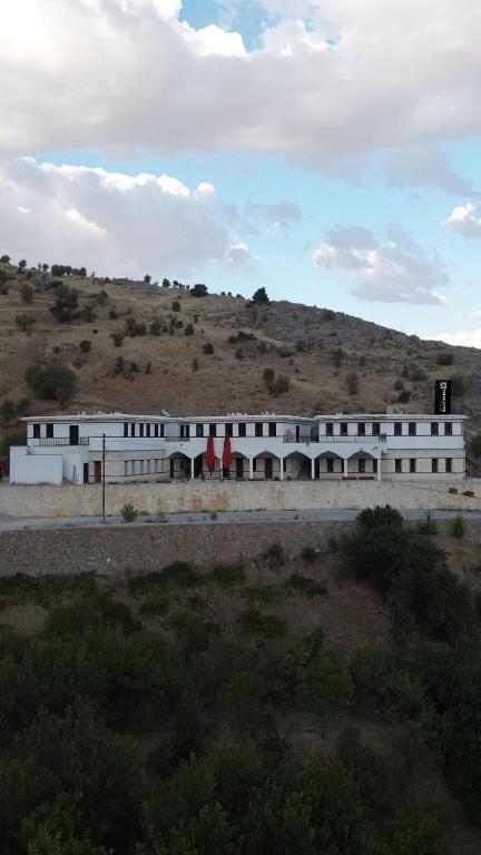 a white building in the middle of a field at Serge Otel in Arapkir