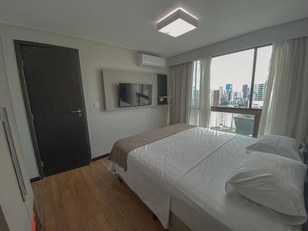 Ένα ή περισσότερα κρεβάτια σε δωμάτιο στο Flat Completo com Cozinha Completa, Piscina e Próximo à Praia de Boa Viagem