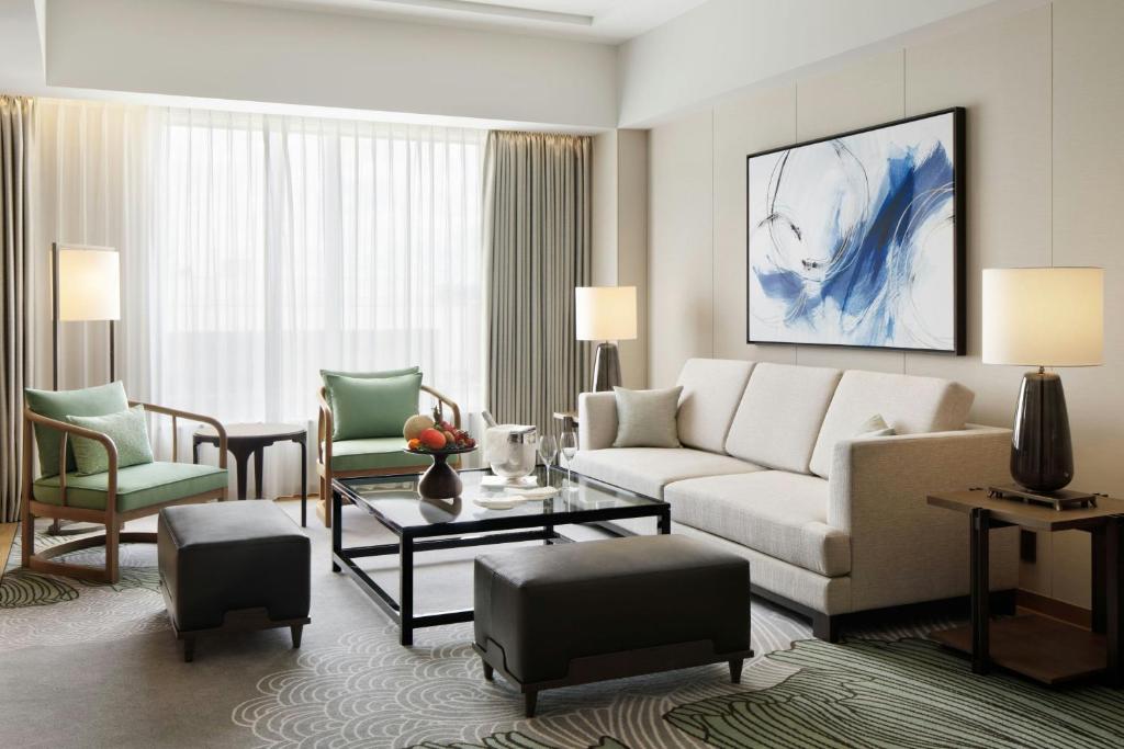 a living room with a couch and a table at JW Marriott Hotel Nara in Nara