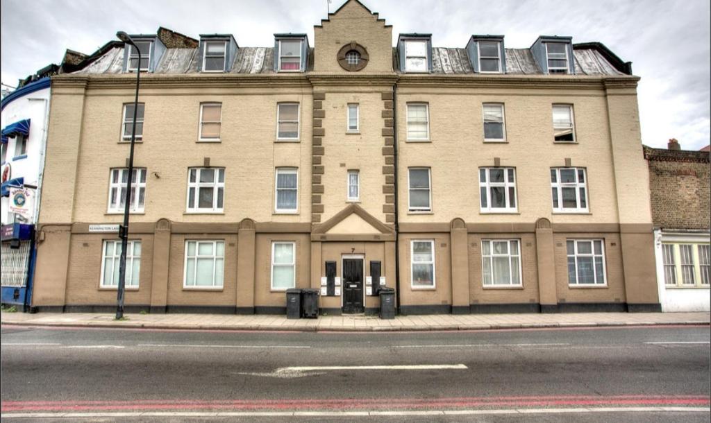a large brick building on the corner of a street at A3-1st Floor 2 Bed Flat near Elephant and Castle in London