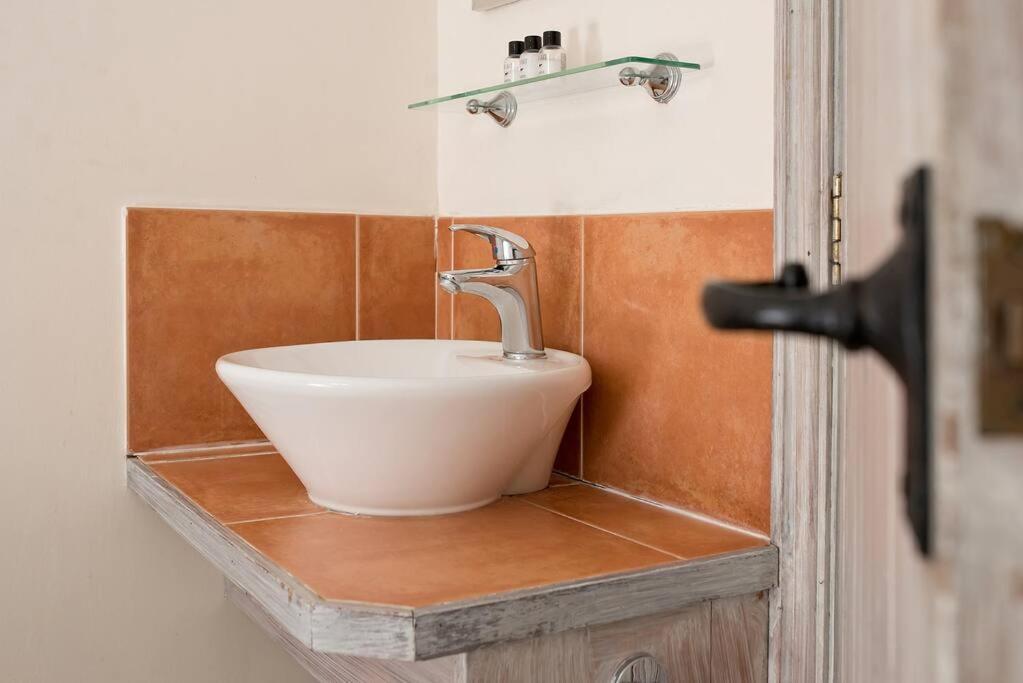 a bathroom sink sitting on a counter next to a door at Willow Lodge In Hexton in Hexton