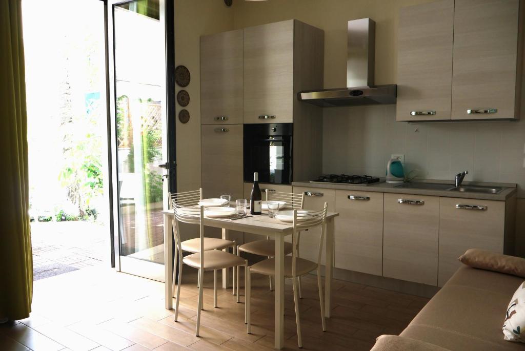 a kitchen with a table and chairs in a room at Lungomare Urban in Pescara