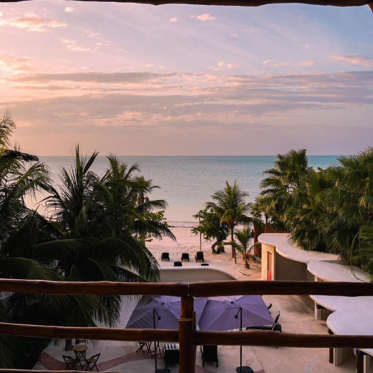a view of the beach from the balcony of a resort at Beachfront Hotel Boutique DK in Holbox Island