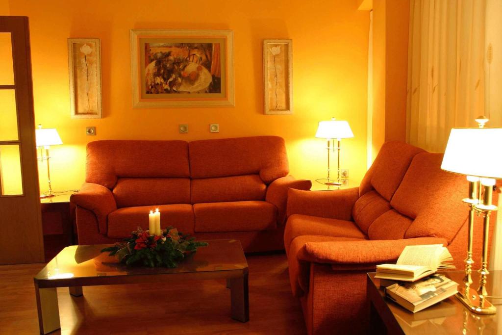 a living room with two couches and a candle on a table at Sol Mediterraneo in Archena