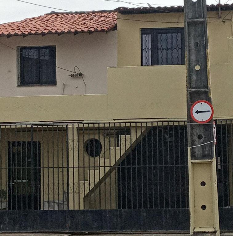 a sign on a pole in front of a house at Casa in Fortaleza