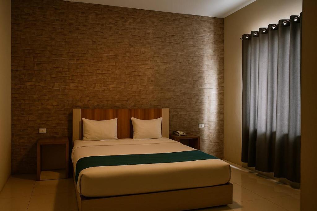 Postel nebo postele na pokoji v ubytování Hotel Amel Aceh
