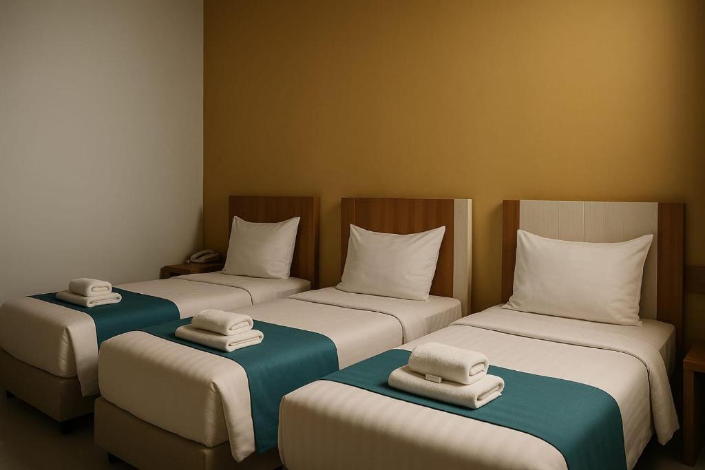 Postel nebo postele na pokoji v ubytování Hotel Amel Aceh