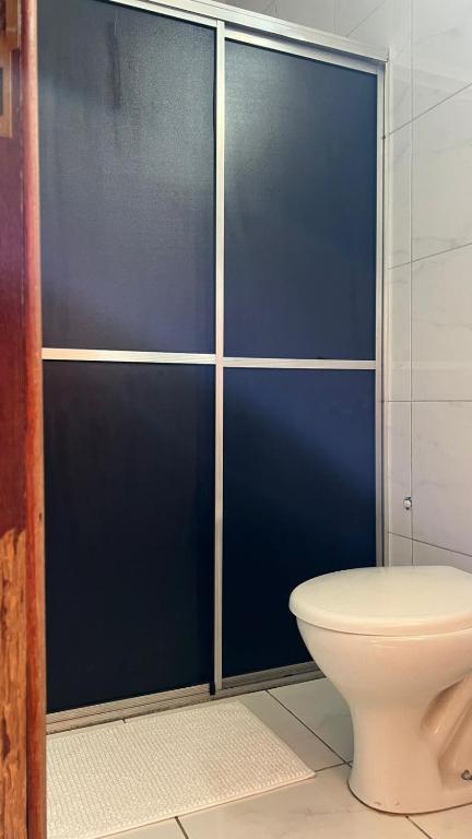 a blue shower stall with a toilet in a bathroom at Condomínio Jardim Presidente 08 in Cuiabá