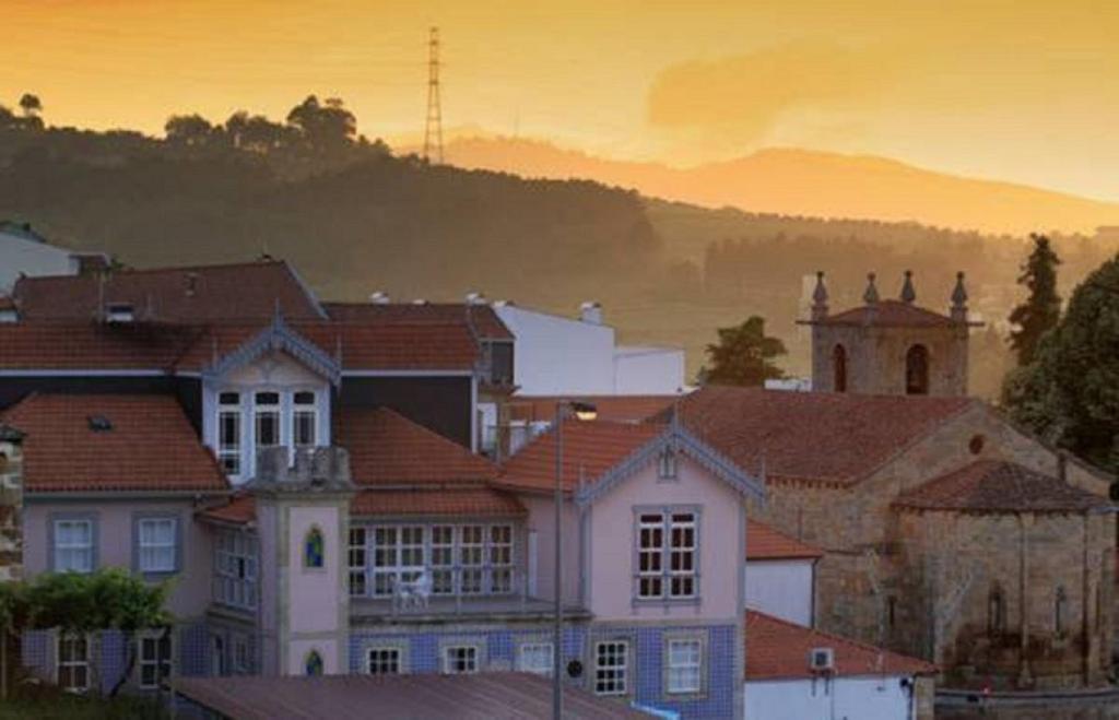 a group of buildings with a sunset in the background at Palacio Nova Seara 2503 - AL in Armamar
