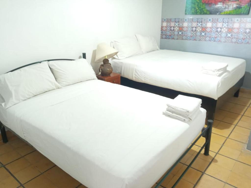 Postel nebo postele na pokoji v ubytování Hotel Gandag