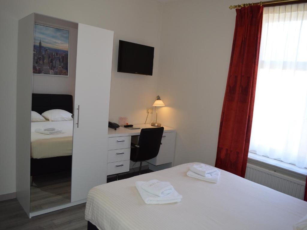 Postel nebo postele na pokoji v ubytování Atlas Village Brielle