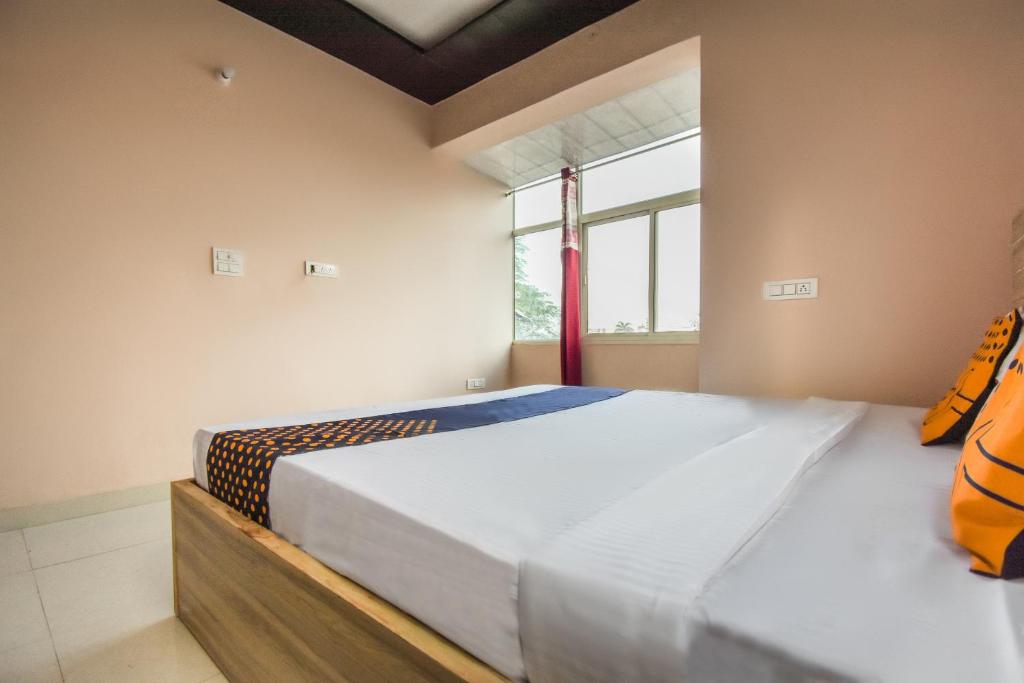 Postel nebo postele na pokoji v ubytování Hotel O Hi Tech