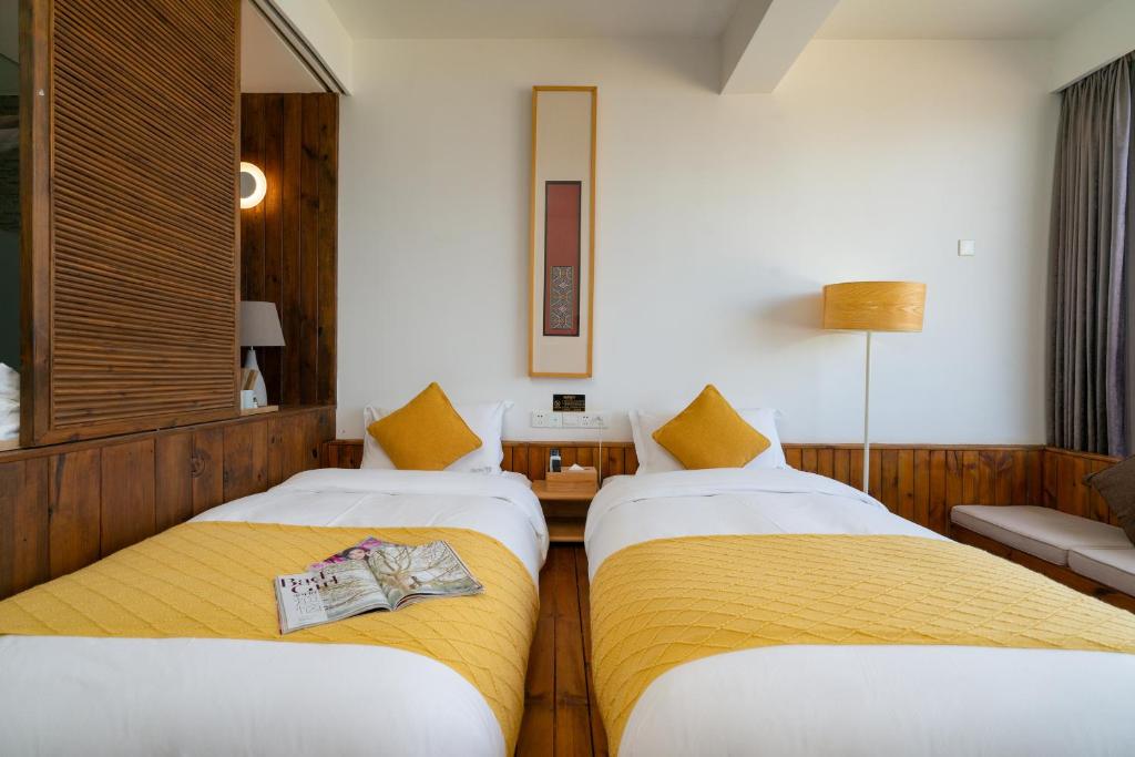 Postel nebo postele na pokoji v ubytování Manwu Dali Jimu Boutique Guesthouse