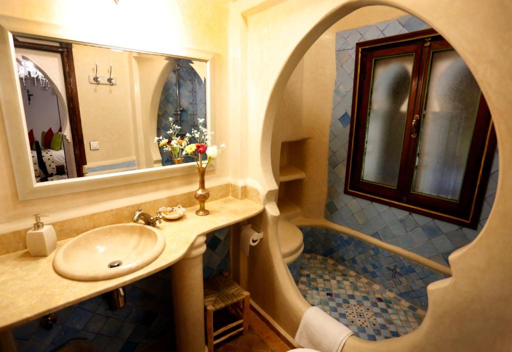 a bathroom with a sink and a shower at Riad Cherifa in Chefchaouene