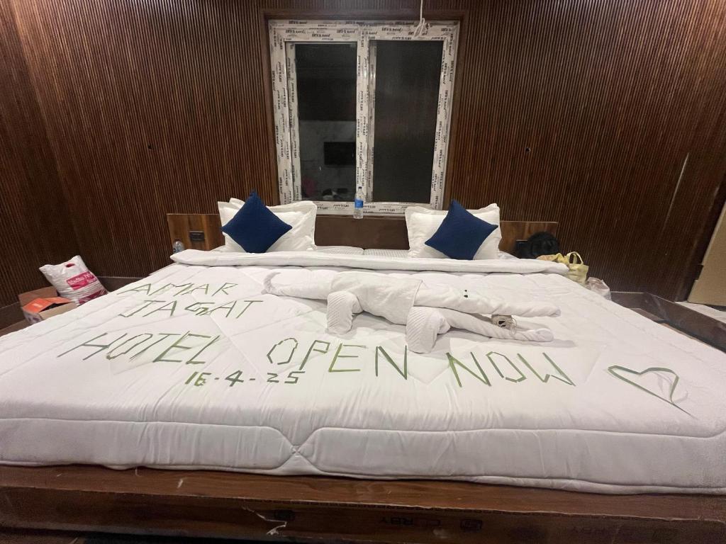a large bed with a sign written on it at AMARJAGAT HOTEL & RESTAURANt in Rudraprayāg