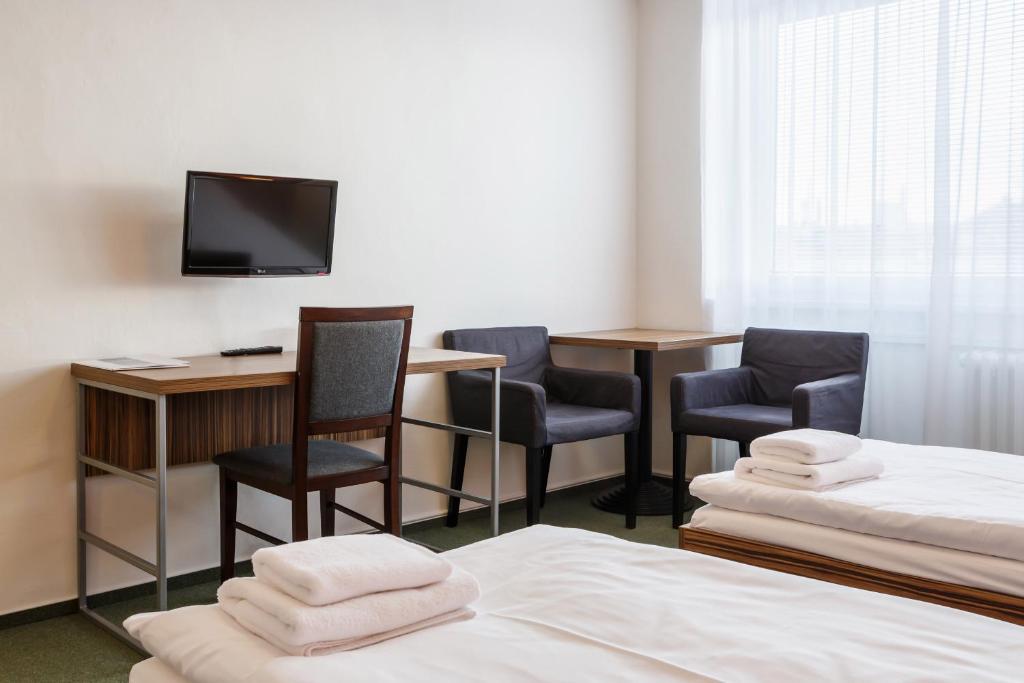 Postel nebo postele na pokoji v ubytování Hotel Veronika