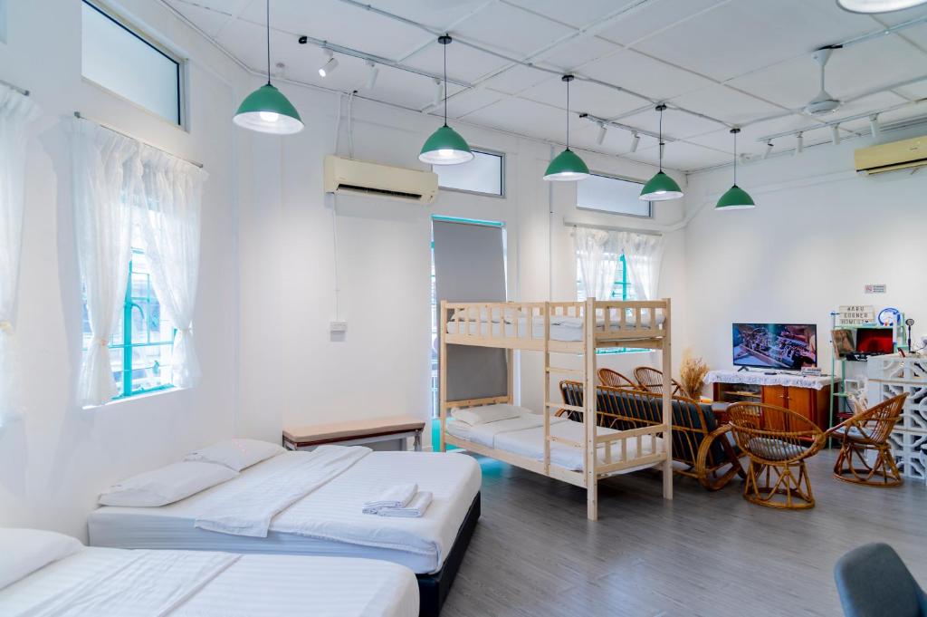 a bedroom with two beds and a bunk bed at Aru corner 6B1BR Tanjung aru town kota kinabalu in Kota Kinabalu