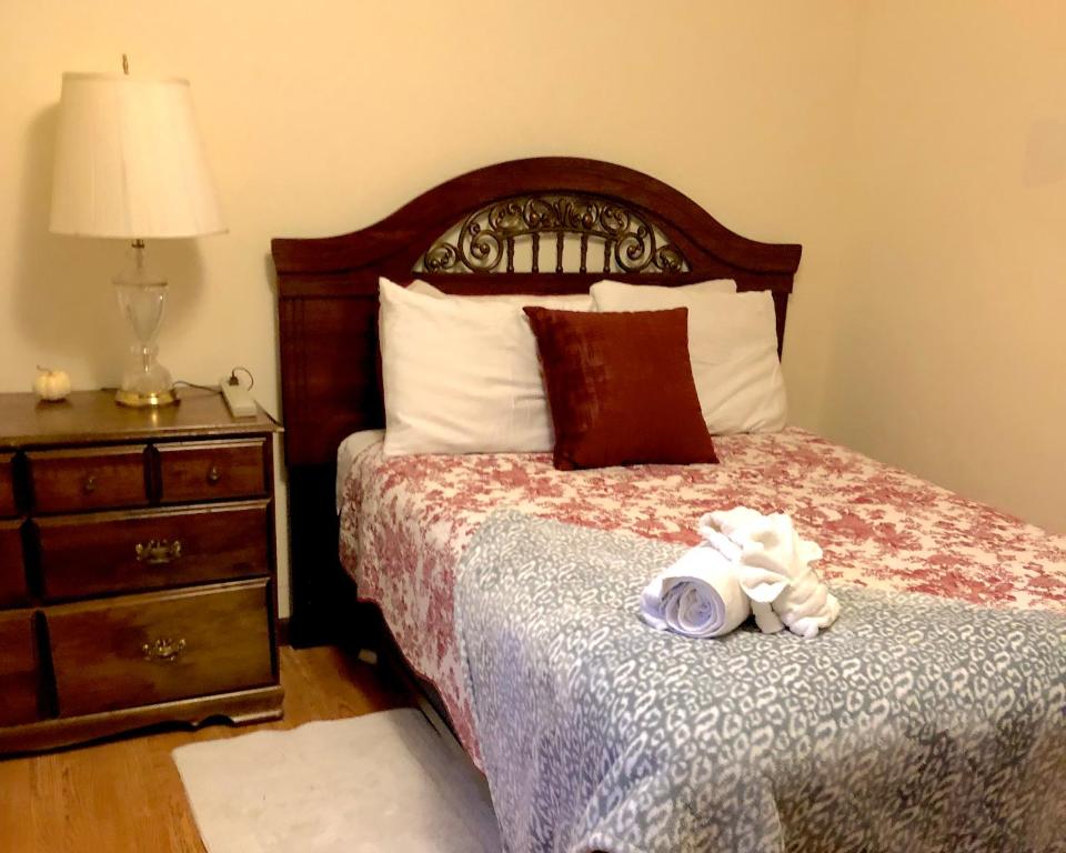a bedroom with a bed and a dresser with a stuffed animal on it at Glacier Guest Room - PRIVATE ROOM IN SHARED HOUSE REDUCED PRICE ON TOURS in Juneau
