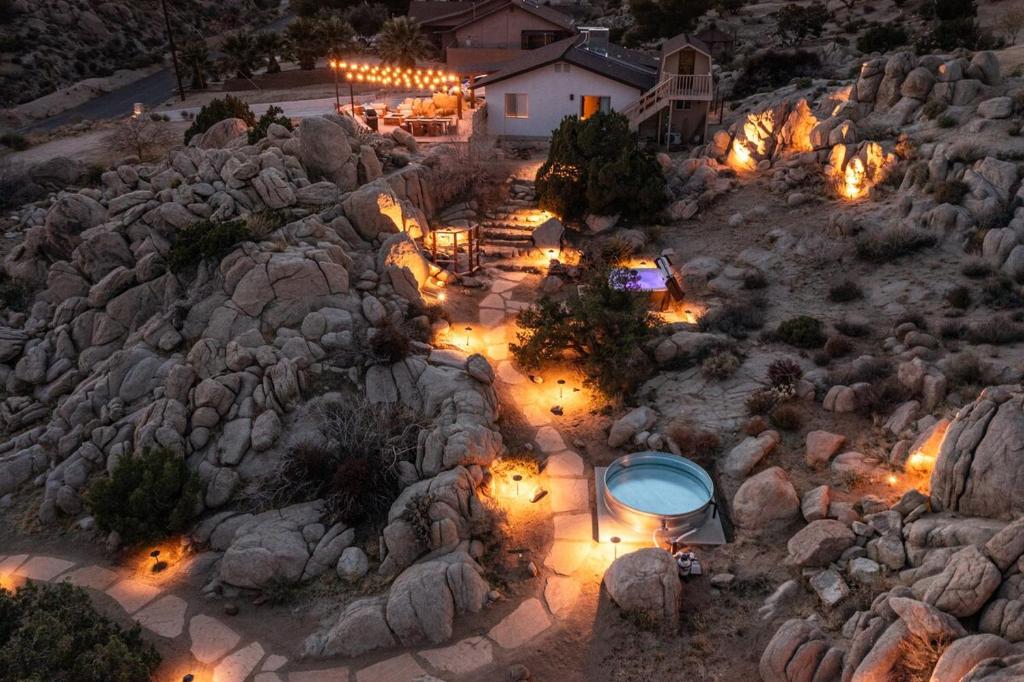 a backyard with lights on a rocky hill at Cozy Retreat Amidst Boulders in Yucca Valley