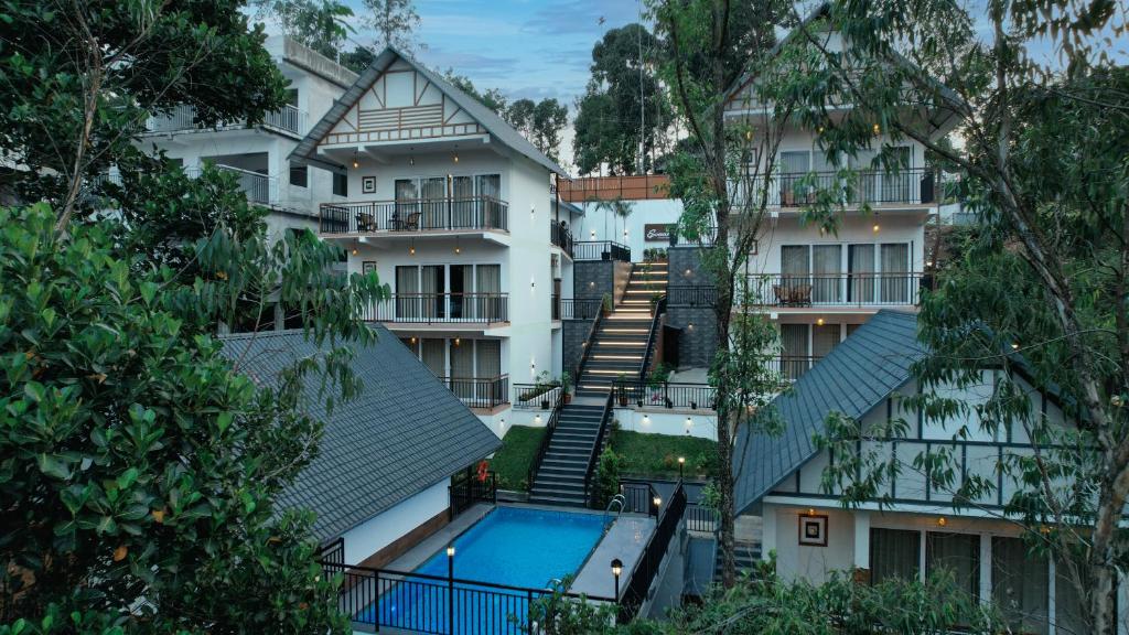 an aerial view of a building with a swimming pool at Evaara Resorts in Anachal
