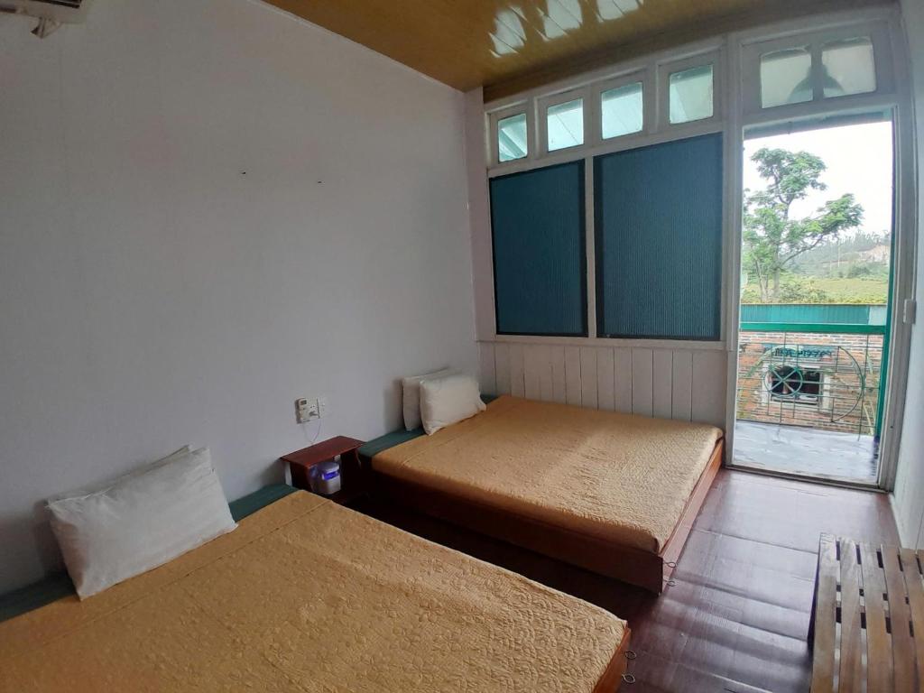 Postel nebo postele na pokoji v ubytování Mina Café & Stay