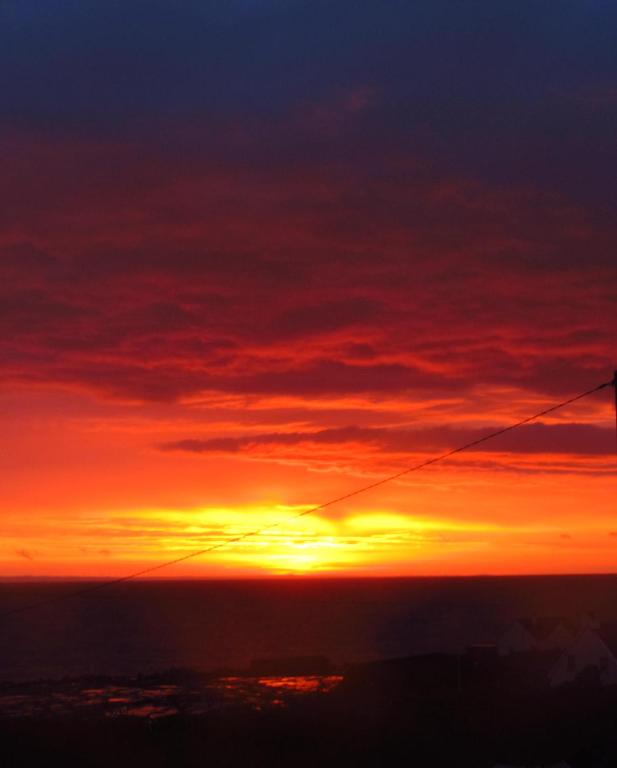 a sunset from the top of a building at An Creagán Rooms in Inisheer