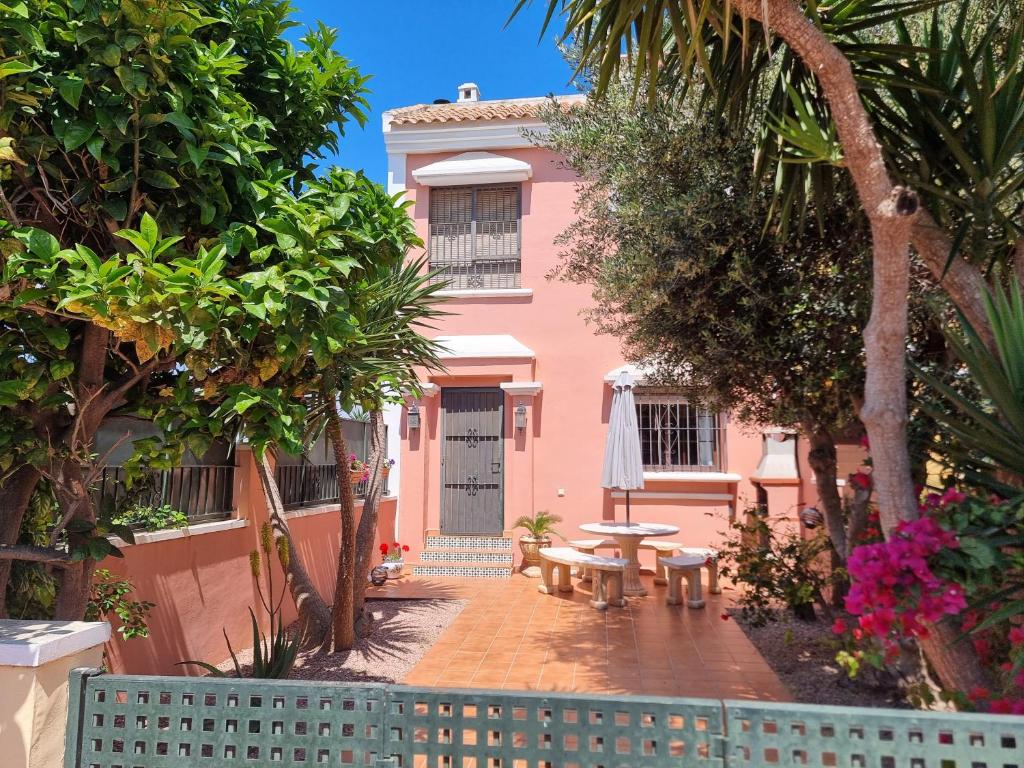 a pink house with a picnic table in front of it at Calle Carlos Primero, Roda in Roda