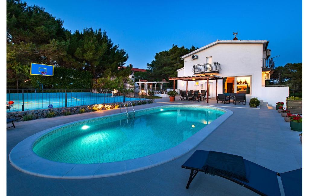 a swimming pool in the middle of a yard at Villa Plenca in Šibenik