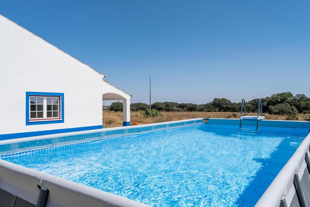 a swimming pool on the roof of a house at Quinta do Mocho by Portus Alacer in Arcos