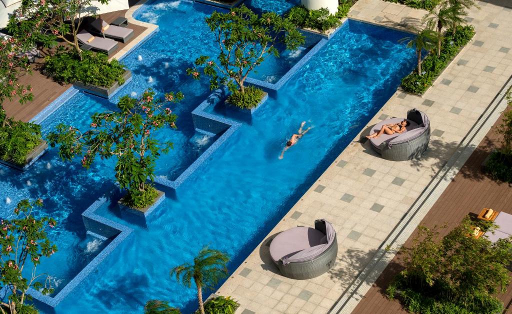 an overhead view of a swimming pool with two boats in it at InterContinental Nha Trang by IHG in Nha Trang