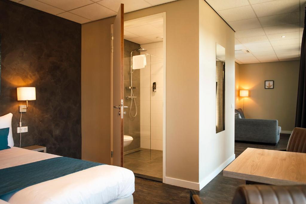 Postel nebo postele na pokoji v ubytování Hotel de Kastanjefabriek