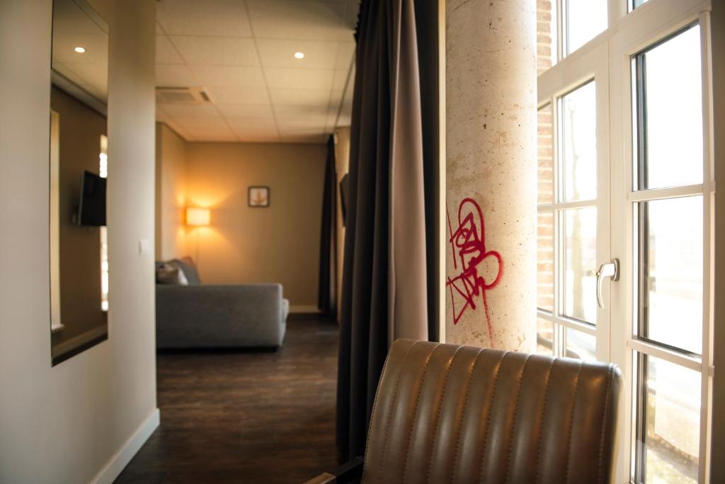 Postel nebo postele na pokoji v ubytování Hotel de Kastanjefabriek