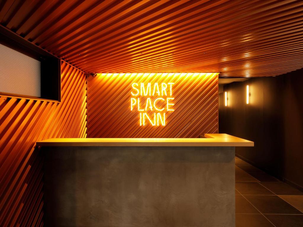 a sign that says smart place inn on a wall at Smart Place Inn Kyoto Shijo Omiya East in Kyoto