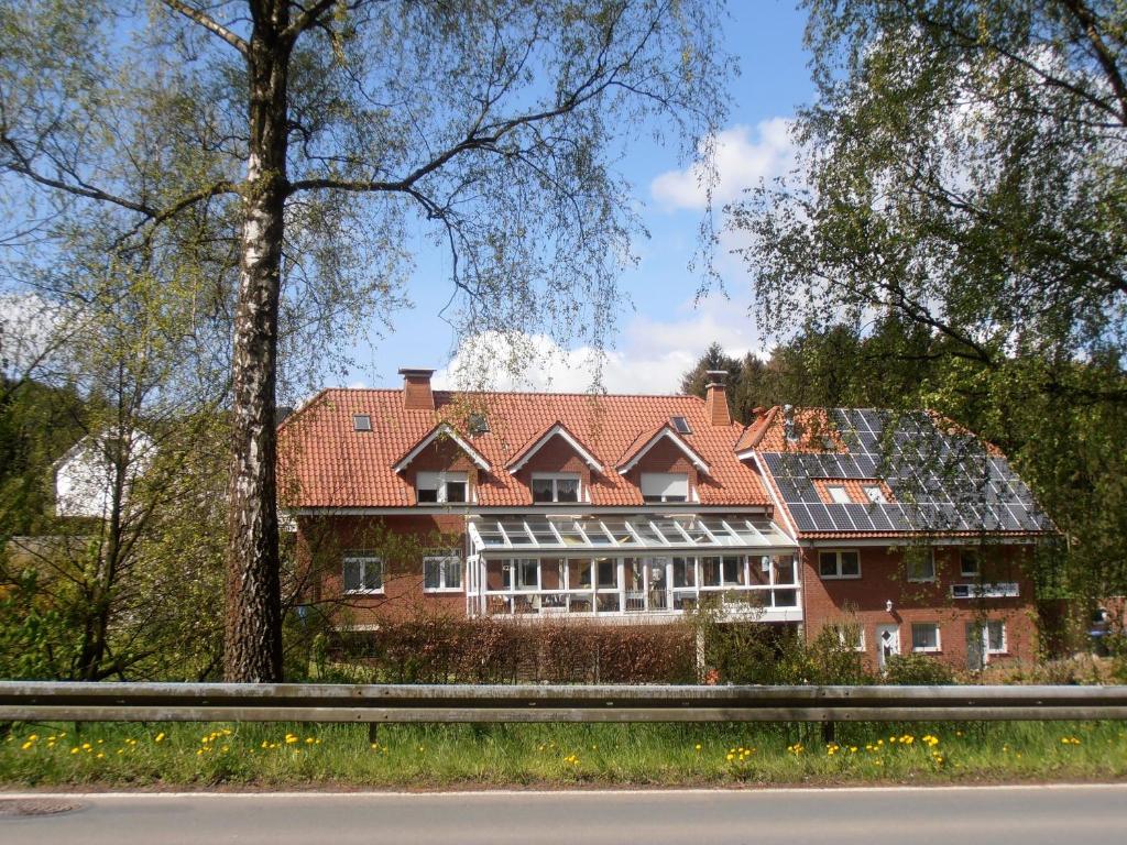 a large red brick house with a red roof at Gasthaus Schadde in Vlotho