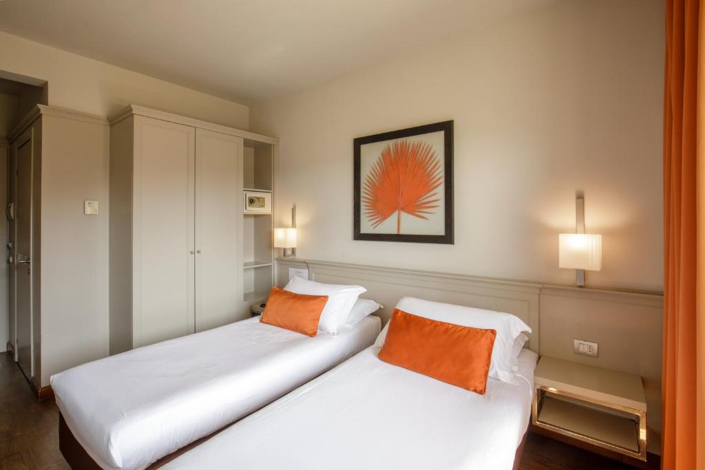 Postel nebo postele na pokoji v ubytování Grand Hotel Fleming by OMNIA hotels
