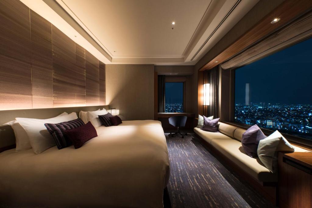 a hotel room with a large bed and a window at Cerulean Tower Tokyu Hotel, A Pan Pacific Partner Hotel in Tokyo