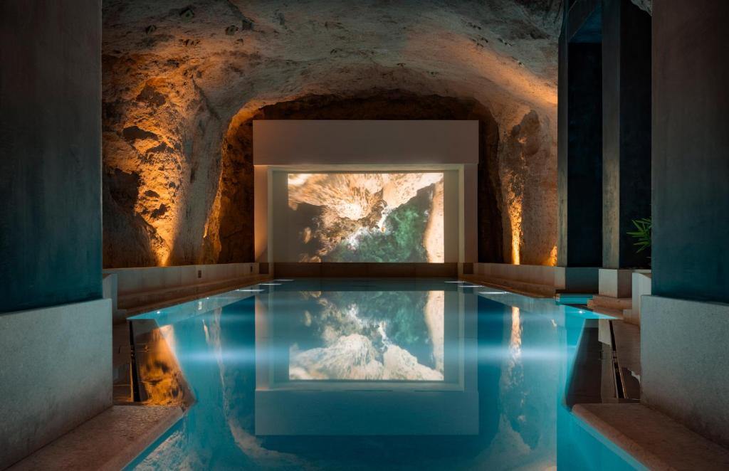 a pool of water in a room with a cave at ME Malta by Meliá in St Julian's