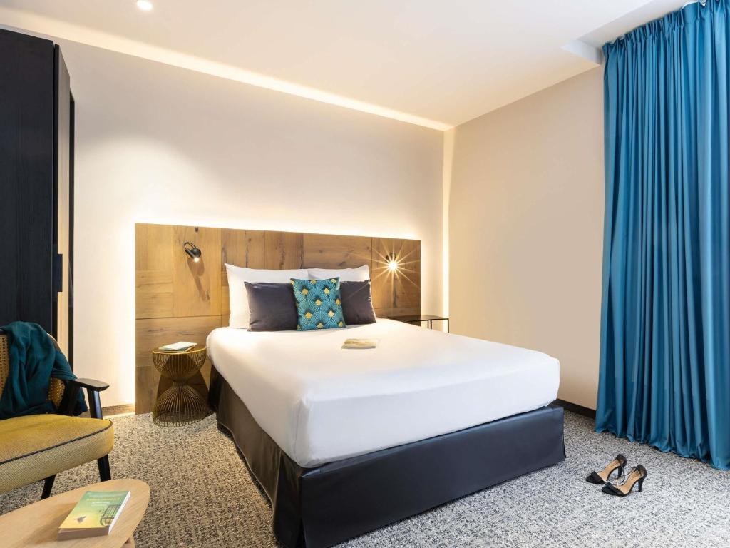 Postel nebo postele na pokoji v ubytování Mercure Epinal Centre