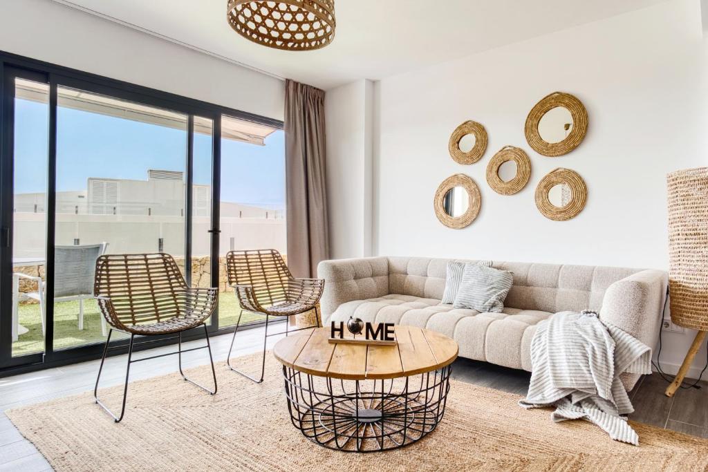 a living room with a couch and chairs and a table at Izabell in Finestrat